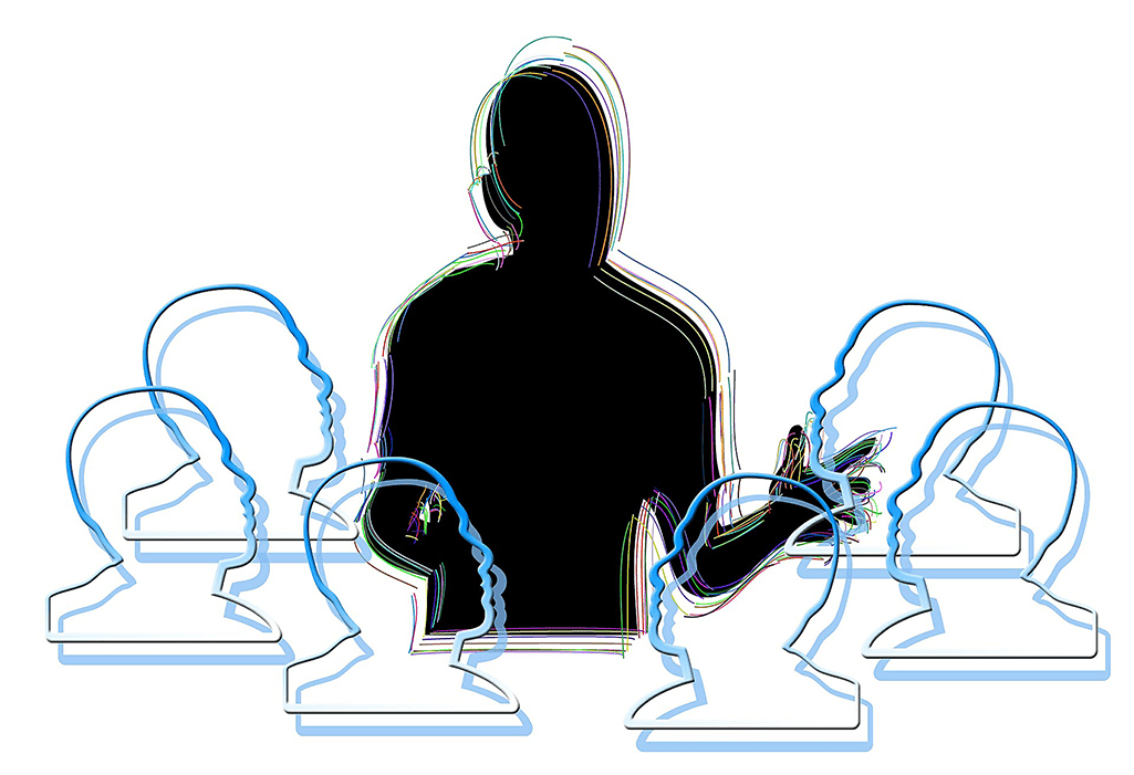 Svart siluett av en lärare fråm midjan och uppåt. Sex elevhuvuden målade som ljusblåa siluetter. Vit bakgrund. Foto: Geralt fråm Pixabay.